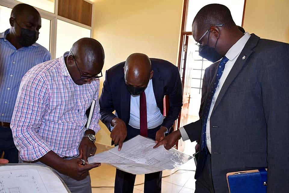 Project team and client representatives reviewing drawings on site